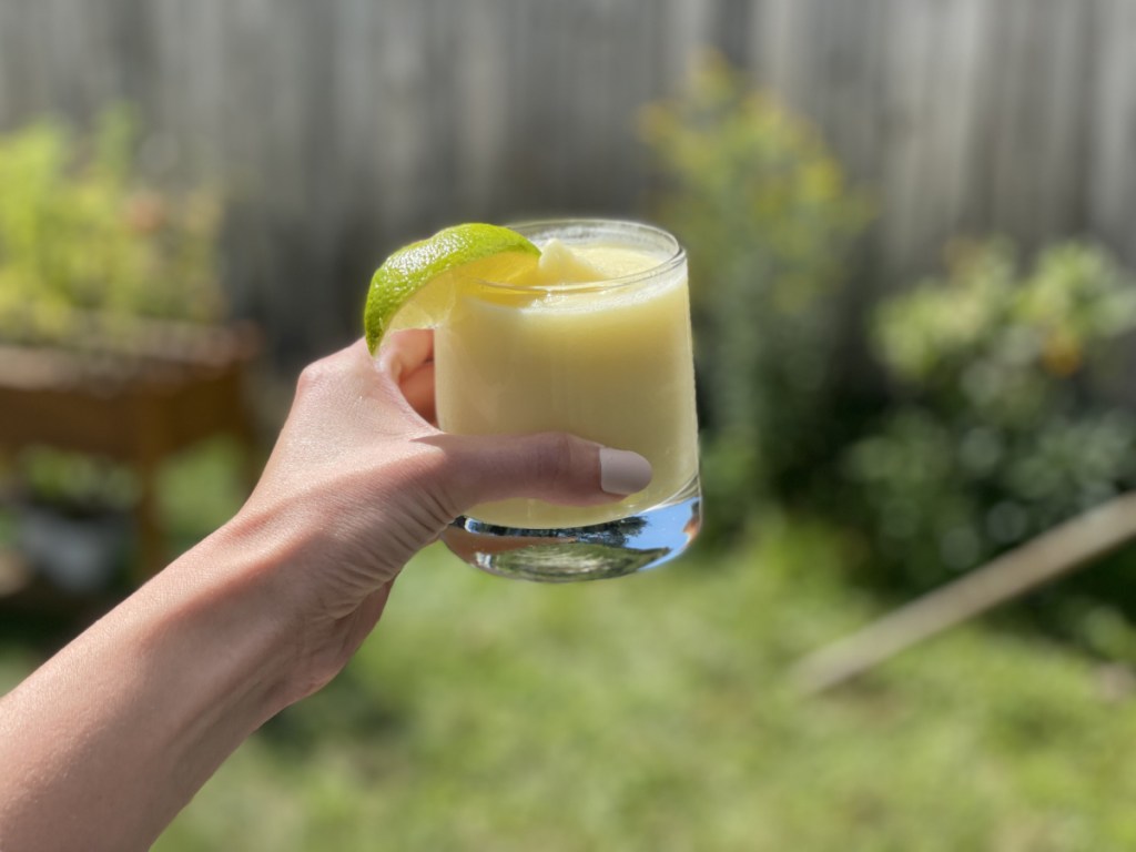 the best piña colada recipe, holding a glass