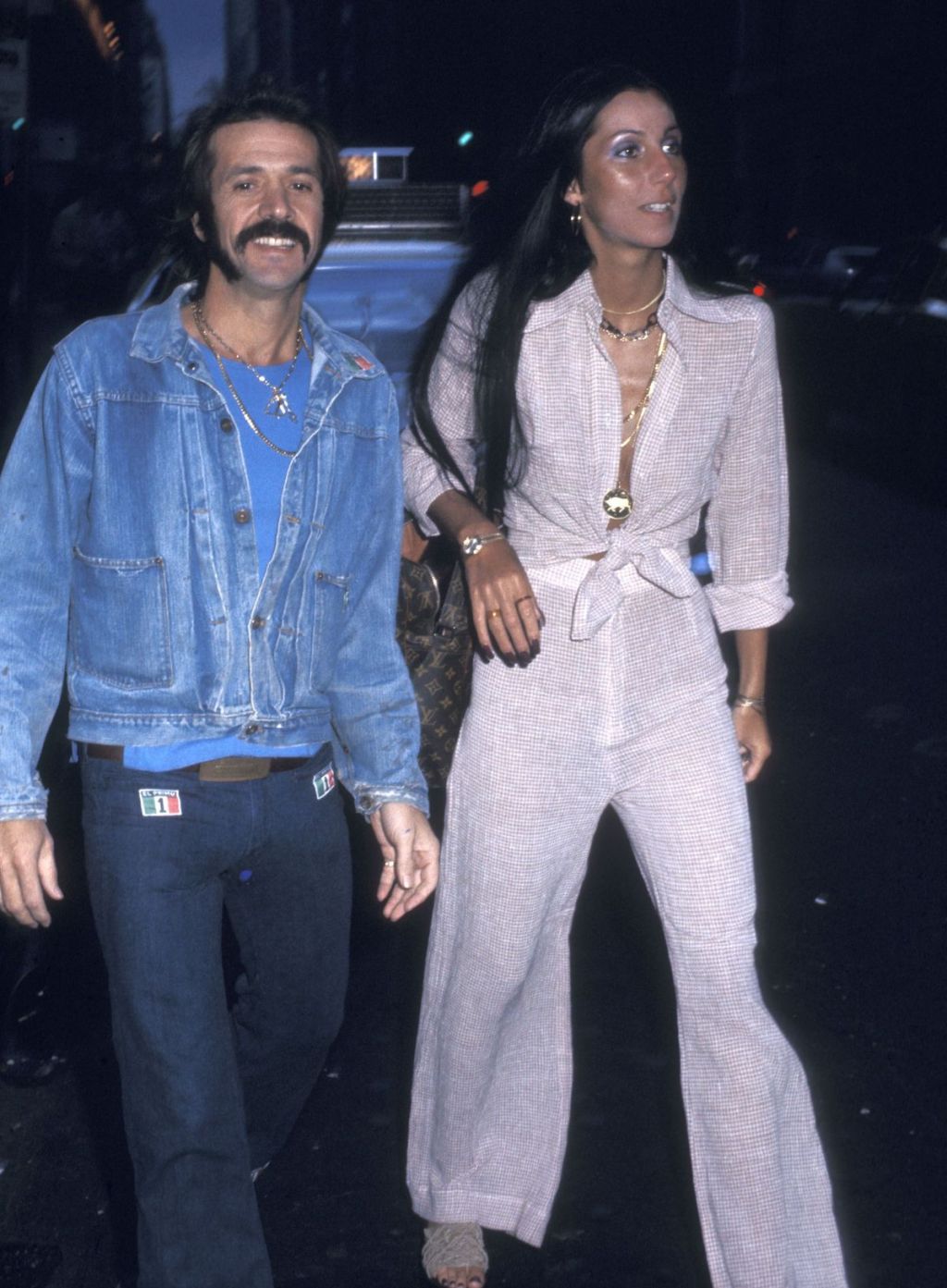 sonny and cher walking outside in dark