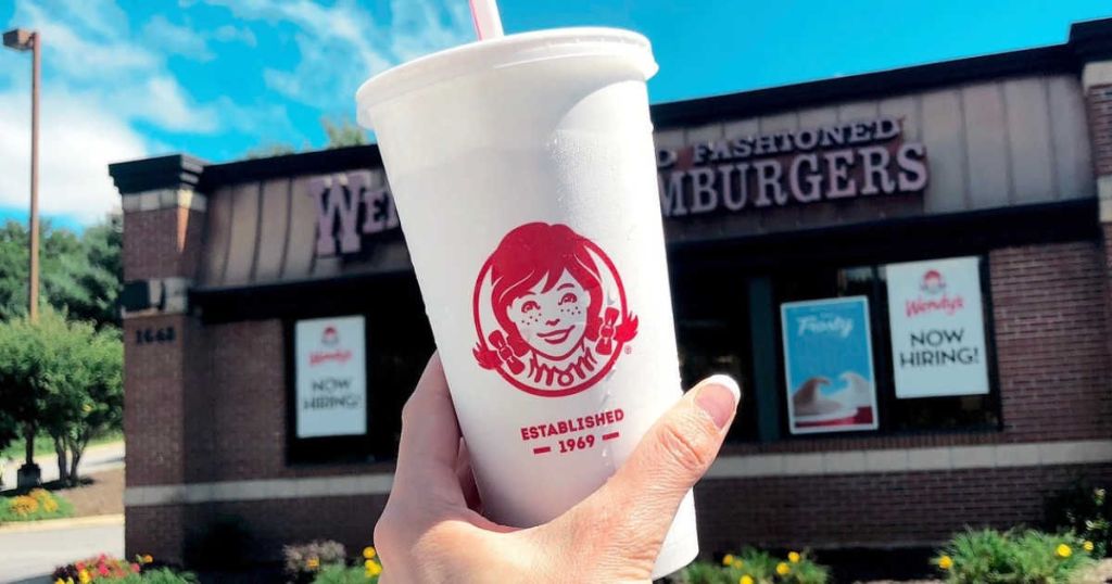 holding a fountain soda outside Wendy's