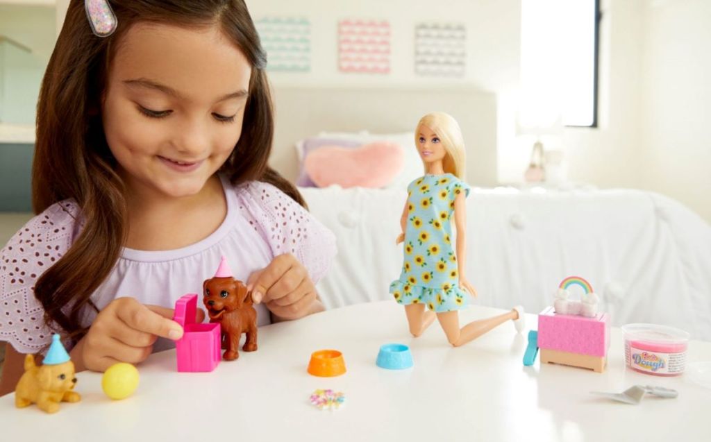 girl playing with Barbie's