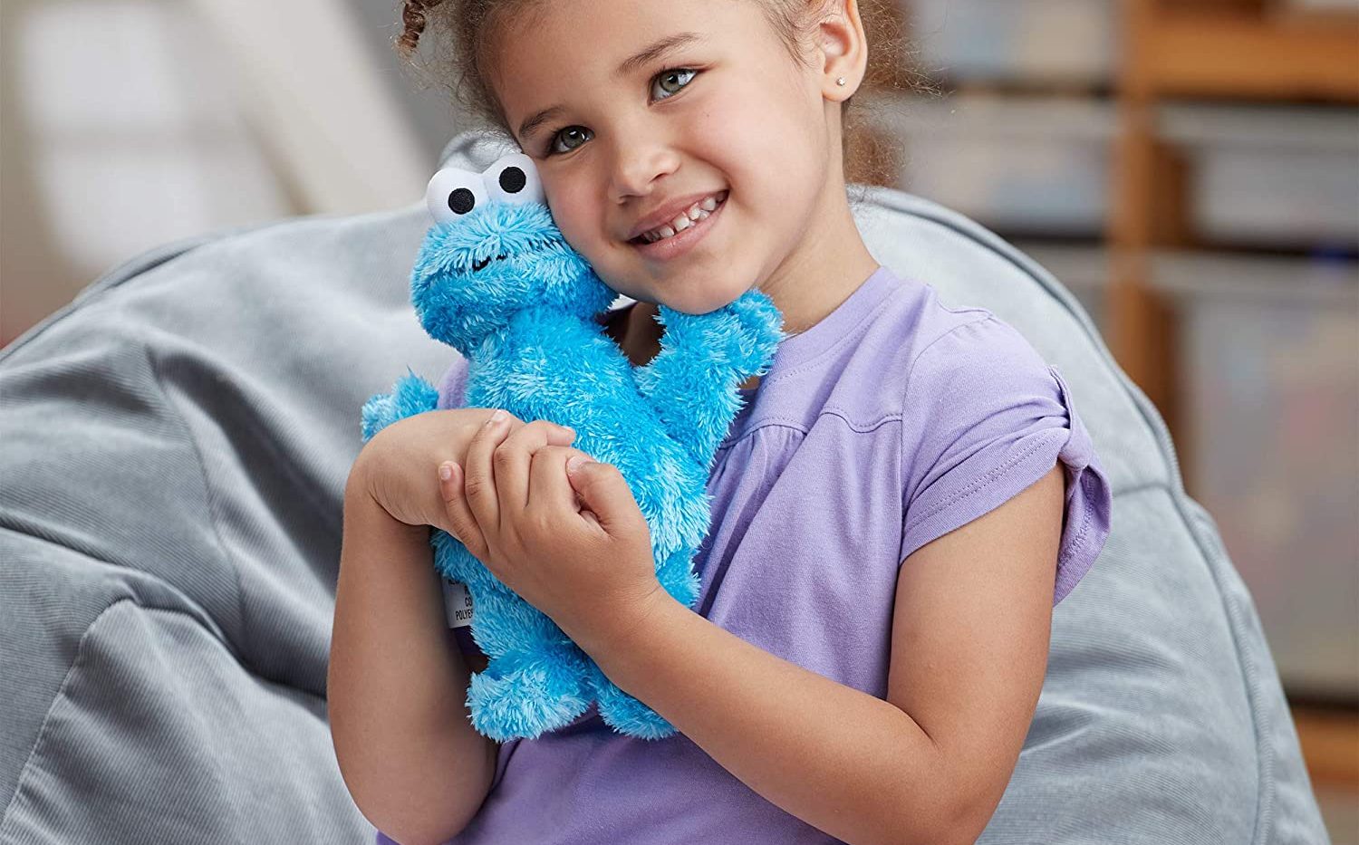 small girl cuddling Cookie Monster 