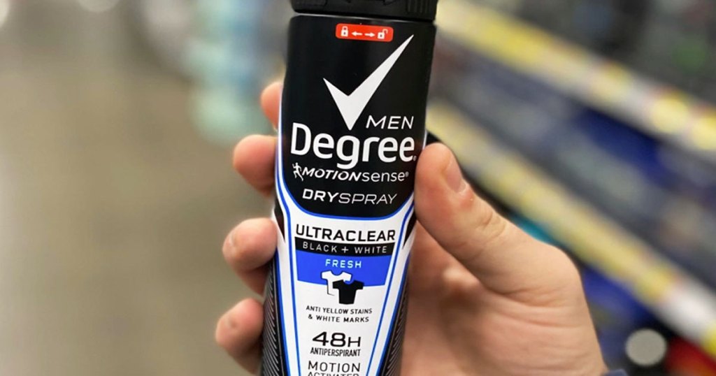 holding bottle of degree men dry spray