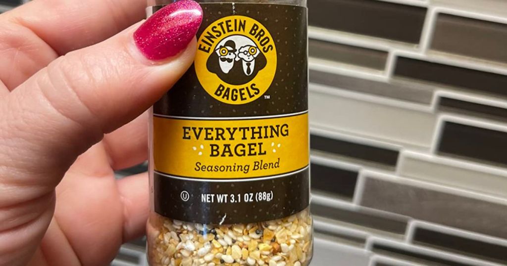 Hand holding a bottle of Einstein Bros Everything Bagel Seasoning