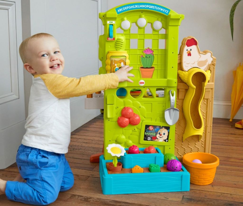 boy playing with a Fisher-Price Playset