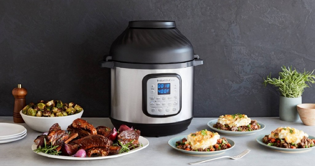 pressure cooker and air fryer onlinebo appliance on counter with plates of food