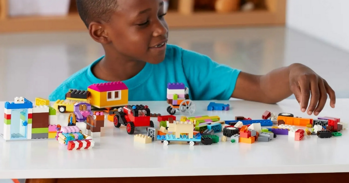 boy playing with lego classic bricks on a roll set