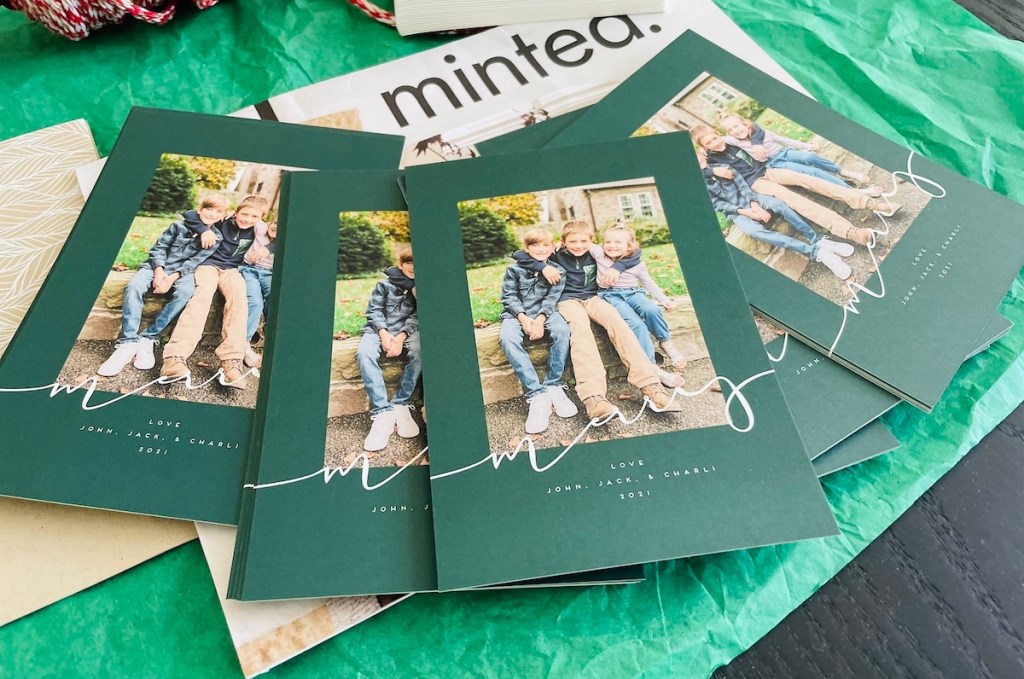 row of Christmas cards on green tissue paper with minted logo