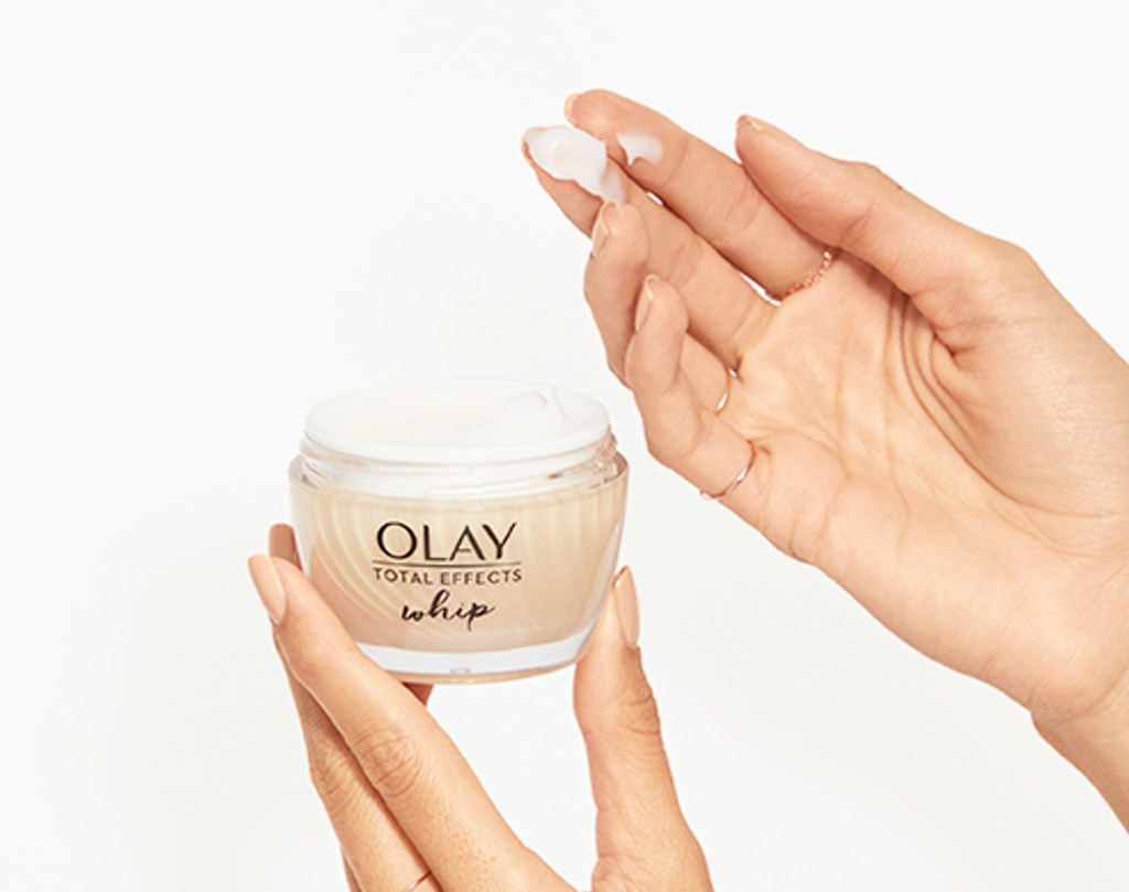 hands holding jar of olay whip moisturizer