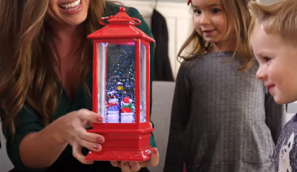 family looking at a snow globe lantern