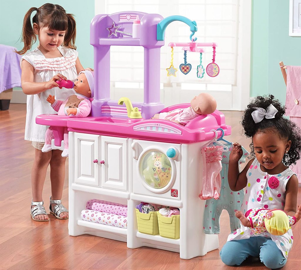 two girls playing with step2 nursery