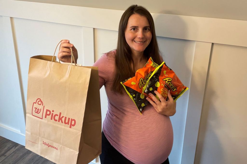 woman holding a Walgreens bag and Reese's