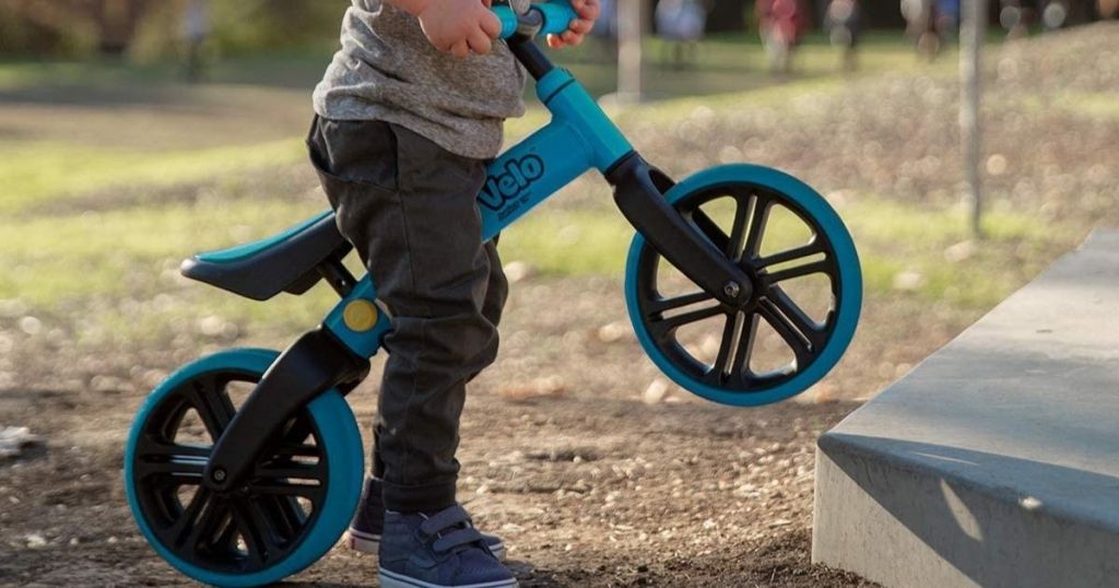 toddler riding blue balance bike