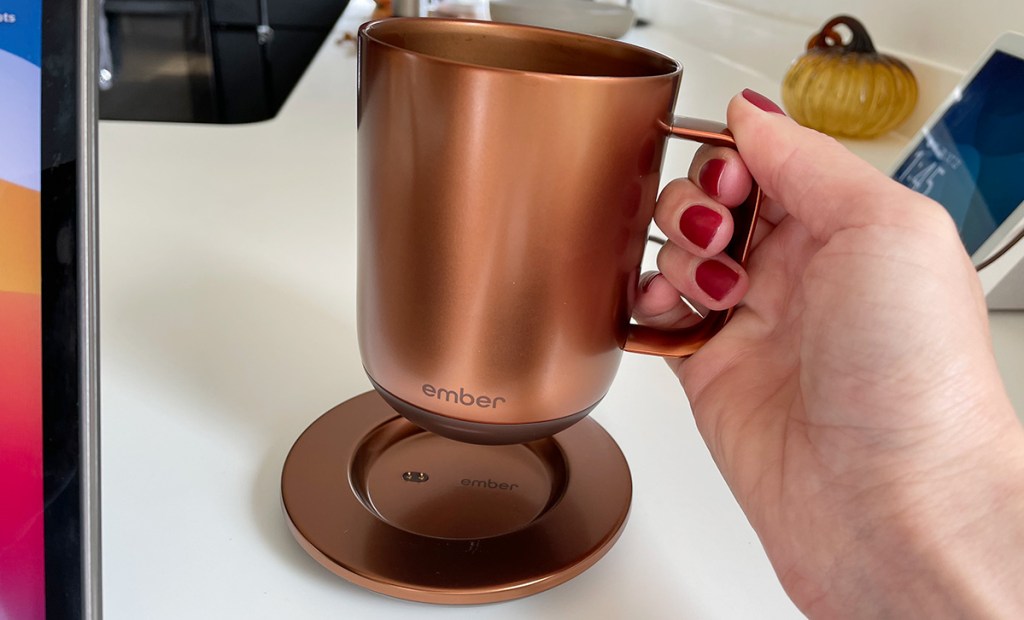 hand holding heating ember coffee mug