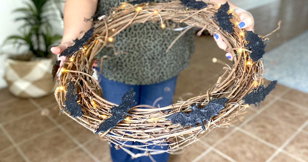 holding out light up bat Halloween wreath