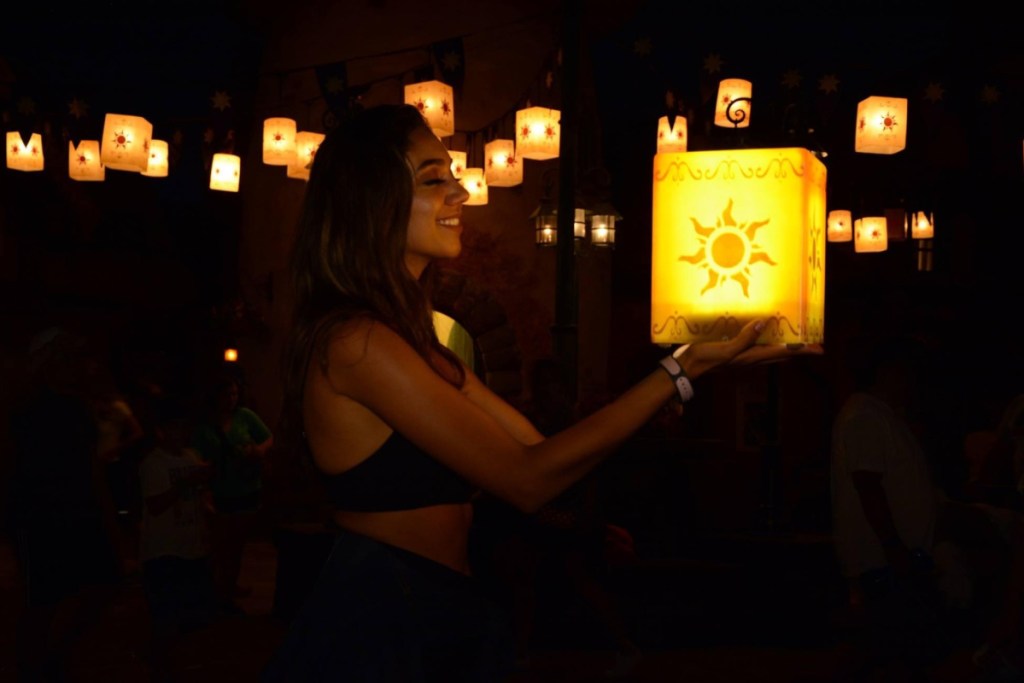 woman lifting lanterns at disney