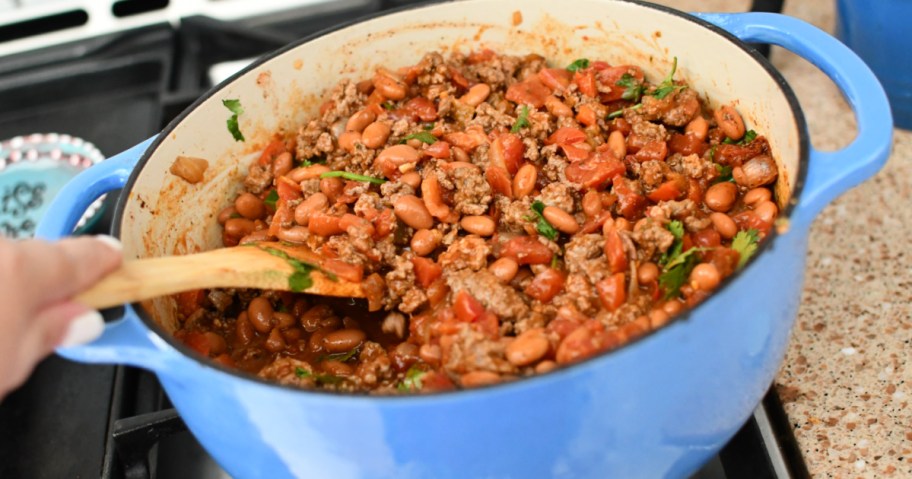 mixing chili in a dutch oven