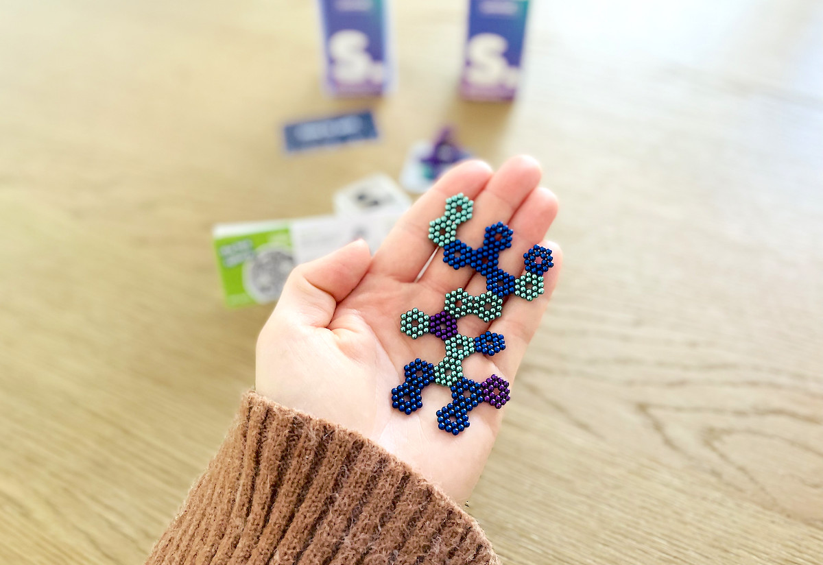 hand holding hexagon shapes in palm of hand