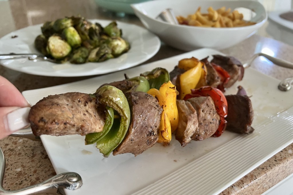 steak kabobs brussels sprouts and fries cooked