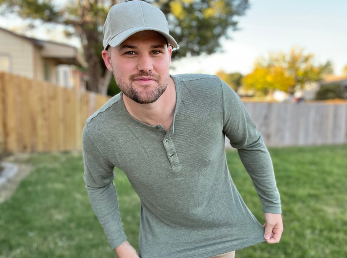 man wearing green Henley style tee