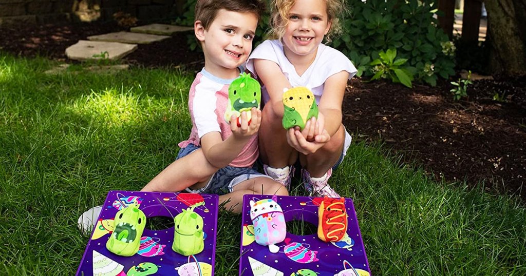 two kids holding cats vs pickles cornhole beanbags