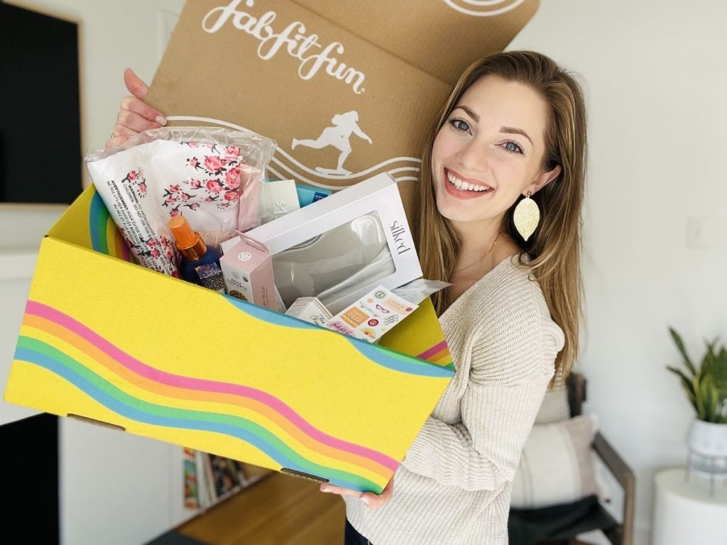 woman holding up fabfitfun box