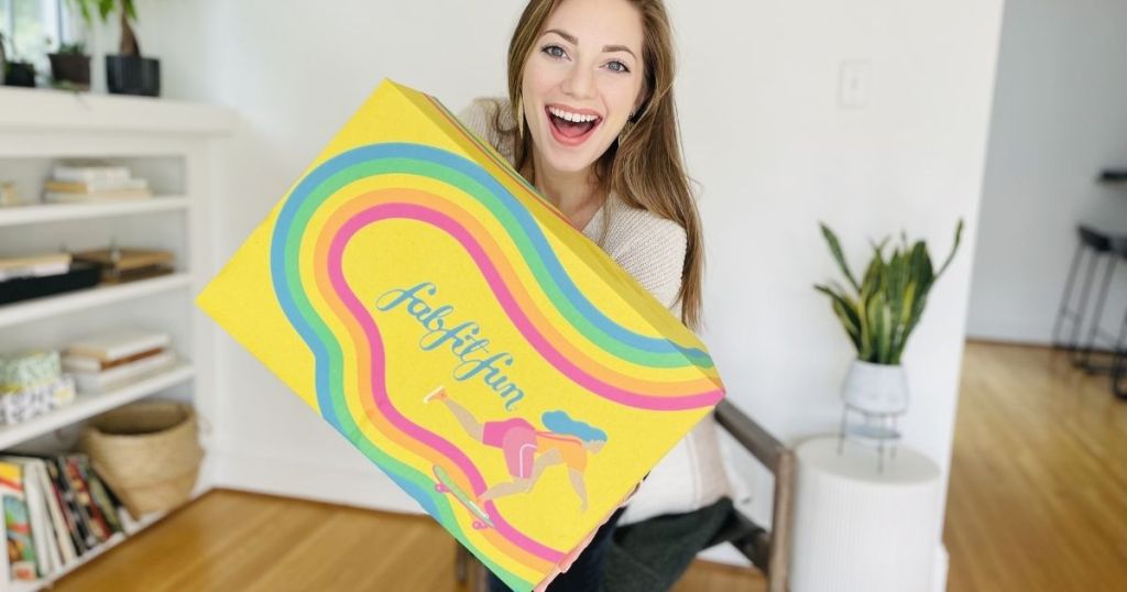 woman holding up fabfitfun box