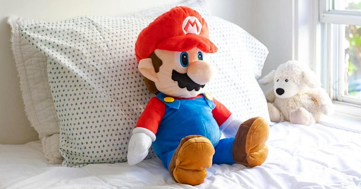 nintendo mario throw pillow on bed