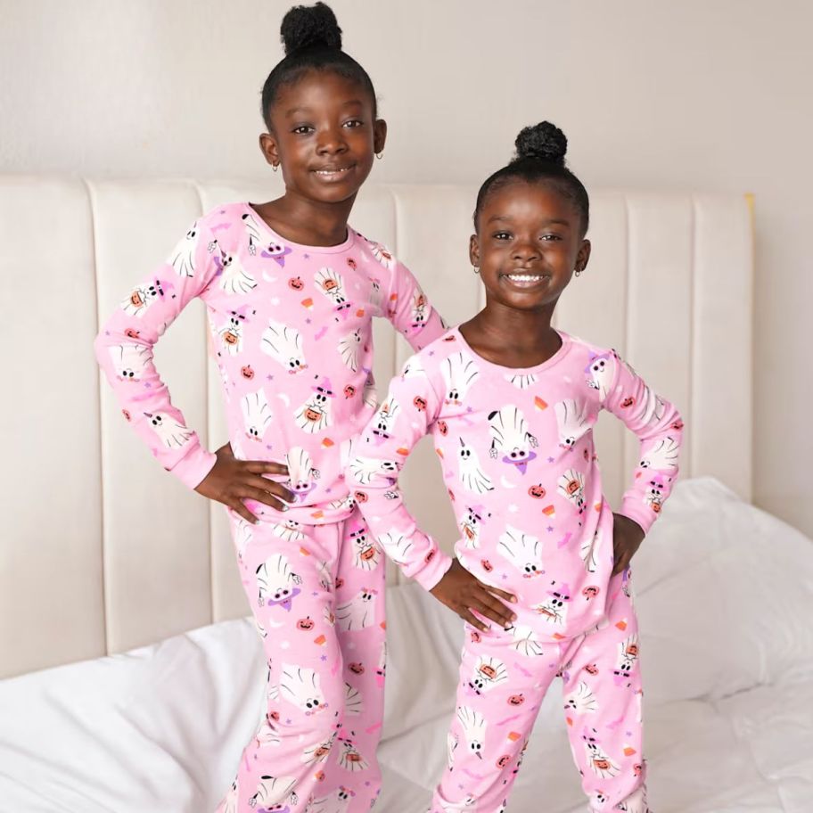 2 little girls wearing matching ghost pajamas