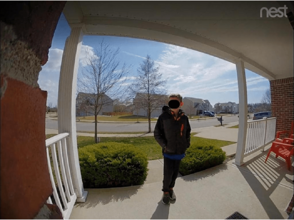 video from doorbell camera of boy standing on front porch