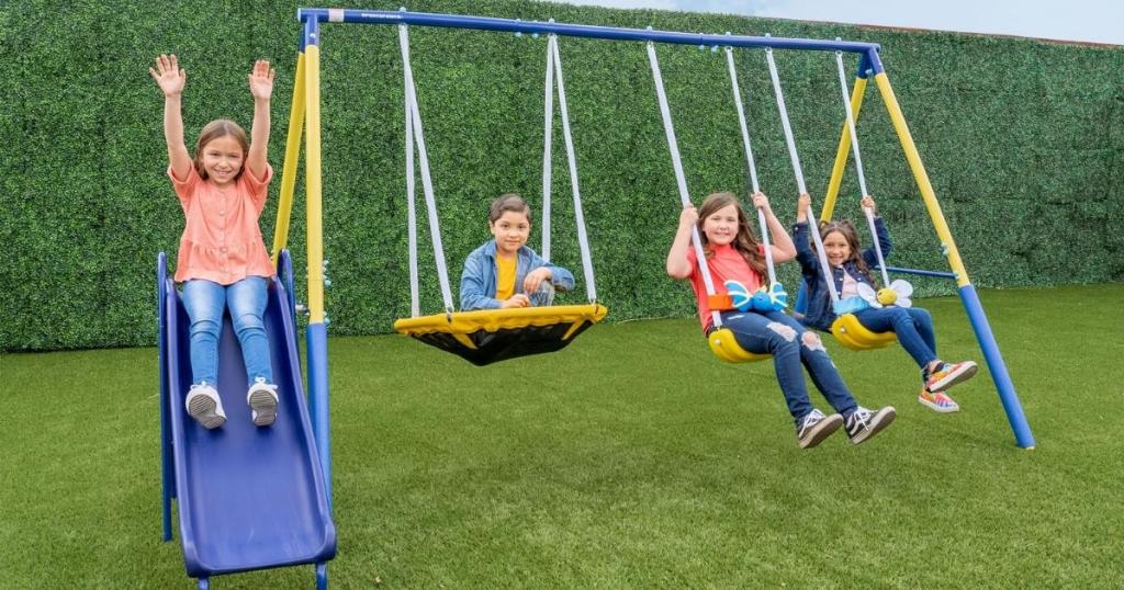 kids playing on sportspower swing set in yard