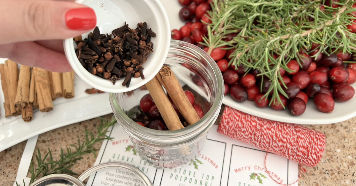 adding cloves and cinnamon sticks