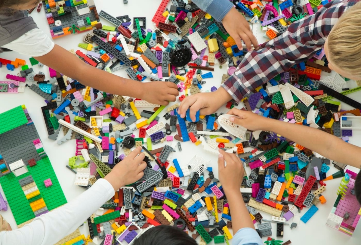 children playing with LEGO on table