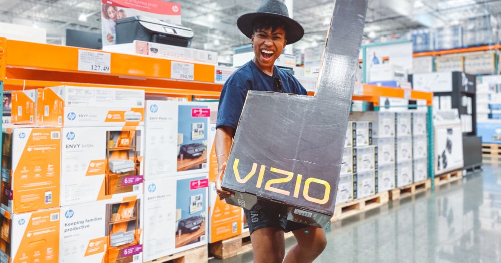 woman holding Costco black friday vizio sound bar