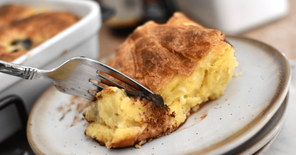 taking bite of bread pudding made with criossants 