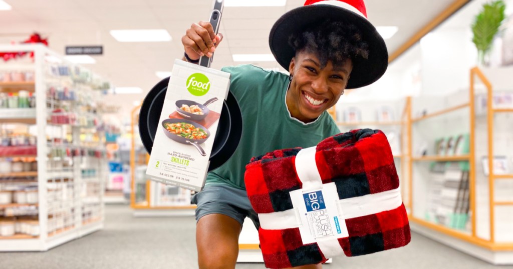 woman holding kohls brand items blanket and food network pans