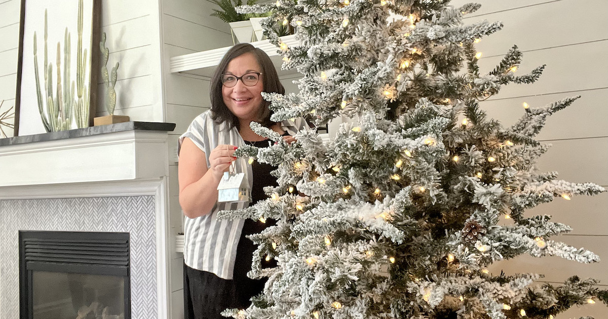 woman standing next to tree with ornaments