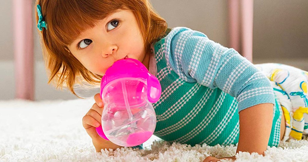 girl drinking out of pink munchkin cup