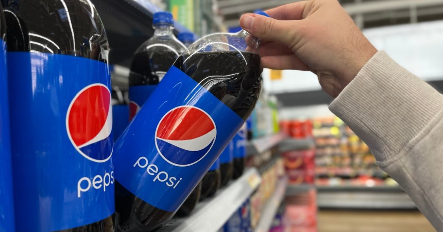 hand grabbing pepsi on shelf