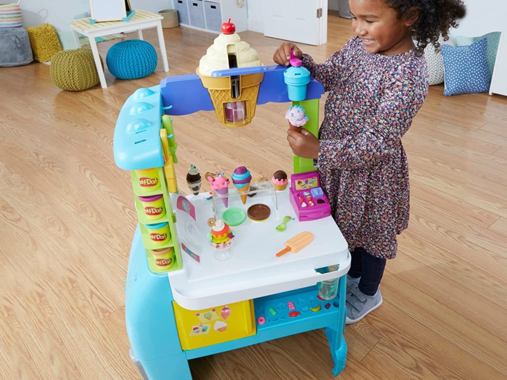 girl playing with Play-Doh ice cream truck