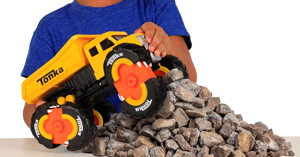 boy playing with a yellow tonka truck