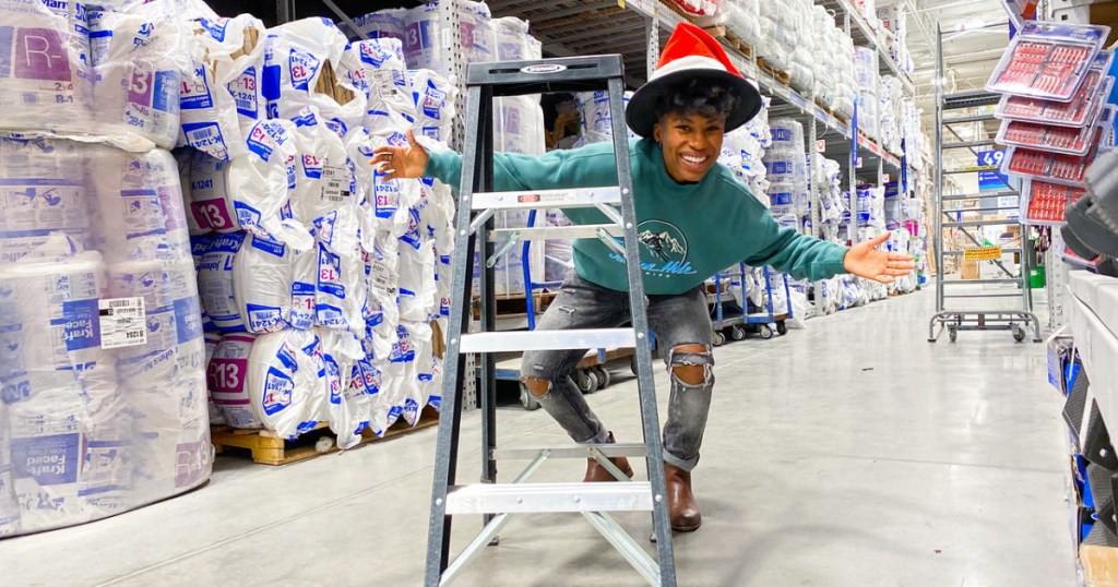 woman posing for a picture behind a ladder