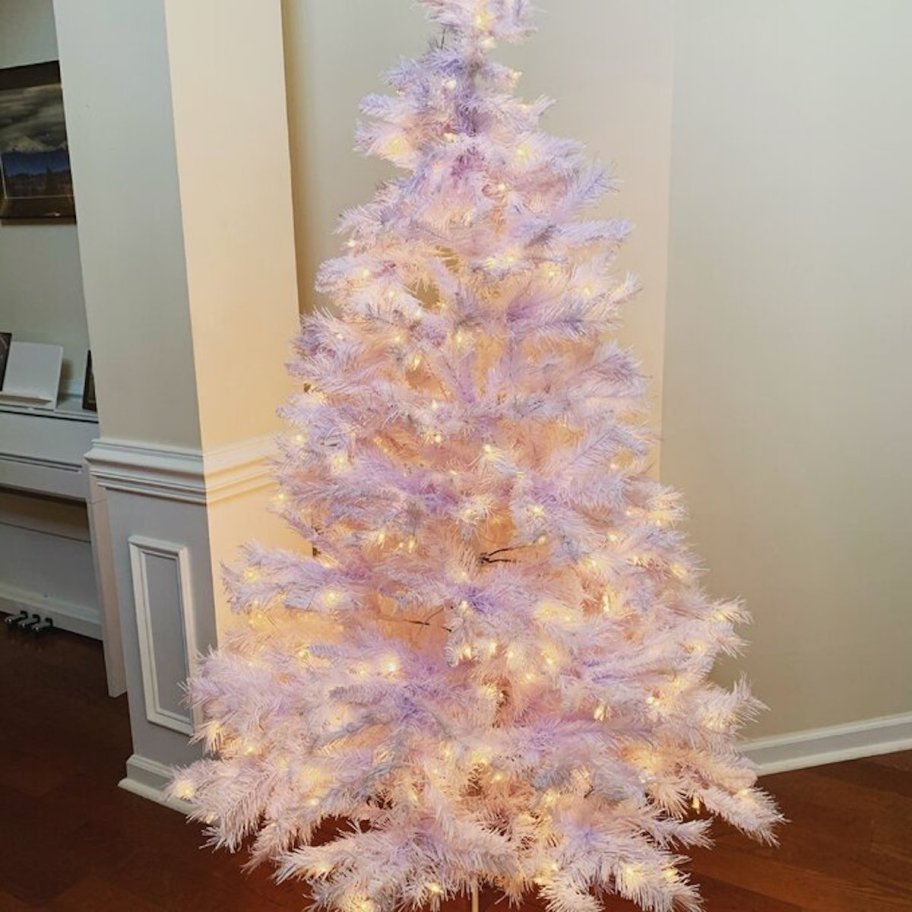 white pre lit christmas tree standing in home