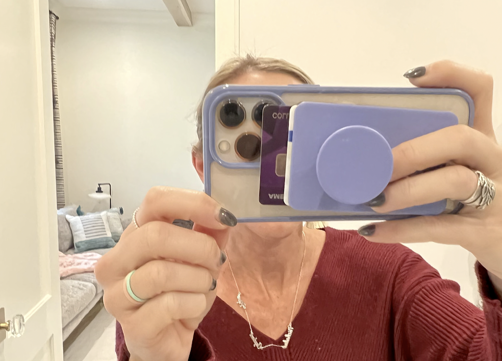 woman holding iPhone with credit card slot 