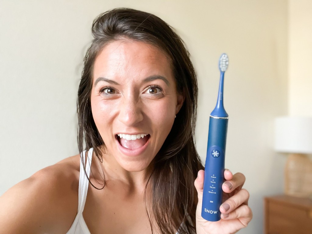 woman holding toothbrush