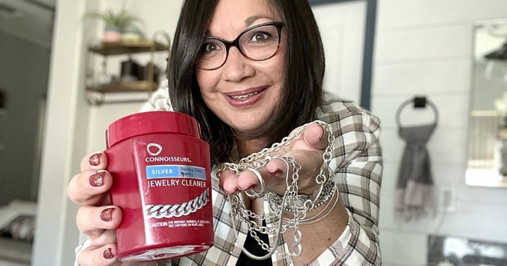 woman holding Connoisseurs Silver Jewelry Cleaner and jewelry