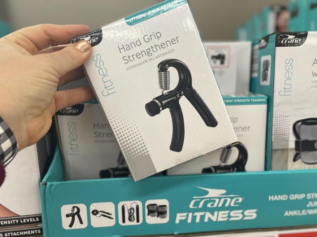 hand holding crane hand grip strengthener in store