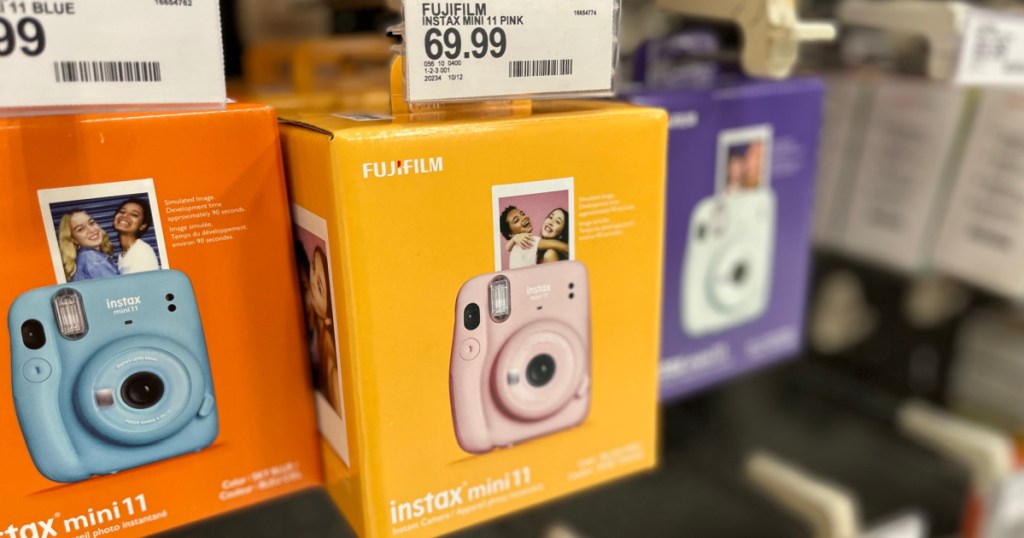 blue pink and white instant film camera on display