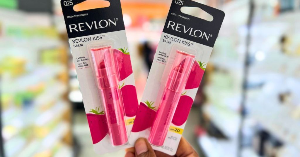 hand holding Revlon Kiss Lip Balms in cosmetic aisle