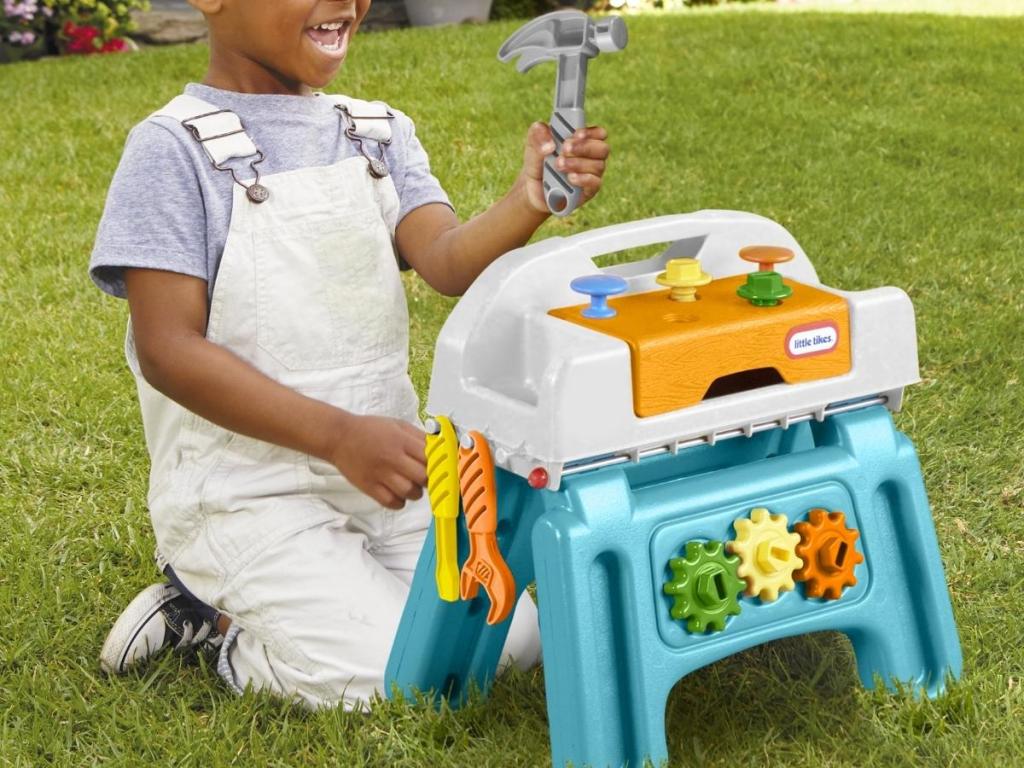 boy playing with little tikes first work bench