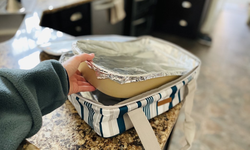 hand holding a casserole pan